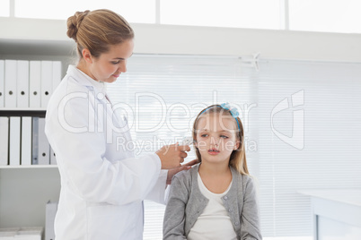 Doctor checking patients ear