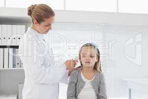 Doctor checking patients ear