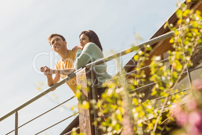 Young couple standing and looking out