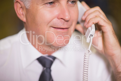 Businessman using telephone