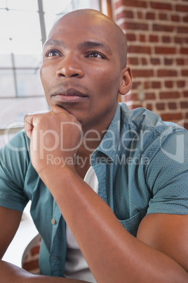 Casual businessman thinking at his desk