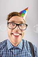 Geeky hipster wearing party hat