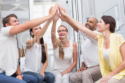 Happy business team high fiving