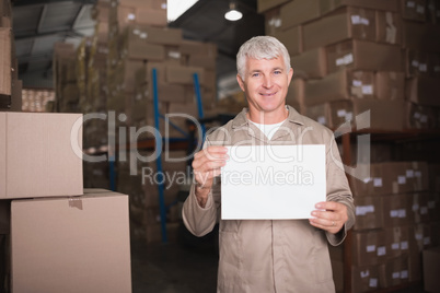 Warehouse worker holding blank board