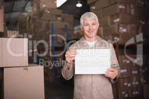 Warehouse worker holding blank board