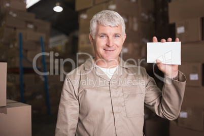 Warehouse worker holding blank paper