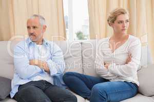 Couple not talking after a dispute on the sofa