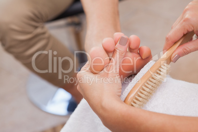 Customer getting pedicure at nail salon