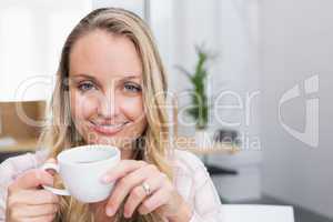 Businesswoman holding coffee mug and smiling