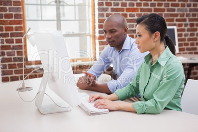 Casual business team working together at desk