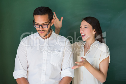 Casual woman shouting at male colleague