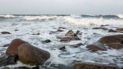 Waves and foam on rocky beach Indian Ocean