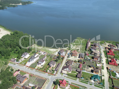 Aerial view onto private houses on bank of lake