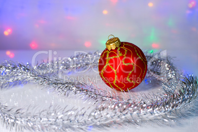 Red Christmas-tree ball and tinsel