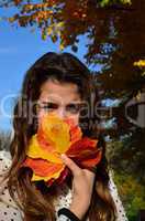 Girl and autumn leaves