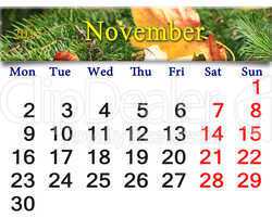 calendar for November of 2015 with yellow leaf on the spruce
