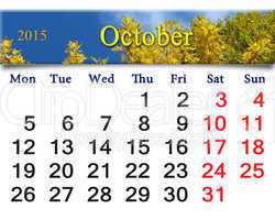 calendar for October of 2015 with autumn leaves and sky