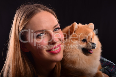 Beautiful girl and Pomeranian dog