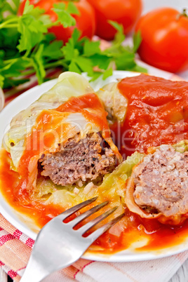 Cabbage stuffed with fork in plate on board
