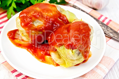 Cabbage stuffed with sauce in plate on board
