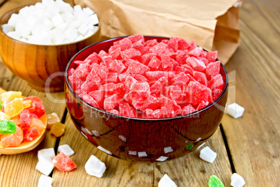Candied fruit colored in bowl and spoon on board