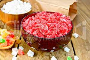 Candied fruit colored in bowl and spoon on board