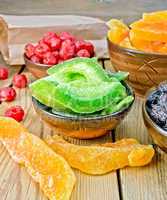 Candied pomelo and fruit in bowl on board