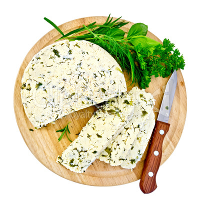 Cheese homemade with knife and herbs on round board