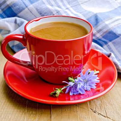 Chicory drink in red cup with napkin on board