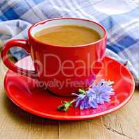 Chicory drink in red cup with napkin on board