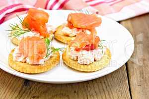 Crackers with cream and salmon on board