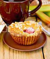 Cupcakes with rhubarb and mug on board