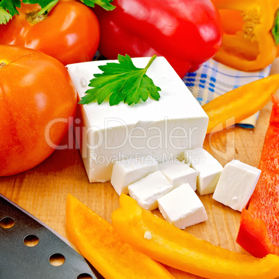 Feta with vegetables and herbs on wooden board