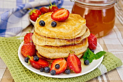 Flapjacks with strawberries and blueberries with napkin