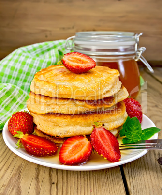 Flapjacks with strawberries and honey on board