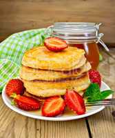 Flapjacks with strawberries and honey on board