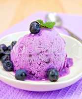 Ice cream blueberry with mint in dish on napkin