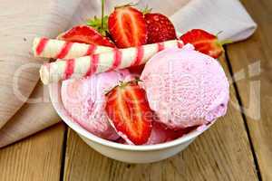 Ice cream strawberry in bowl with wafer rolls on board