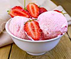 Ice cream strawberry in bowl on board with cloth
