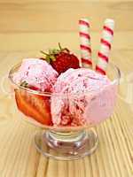 Ice cream strawberry in glass goblet on board