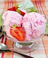 Ice cream strawberry in glass goblet on tablecloth