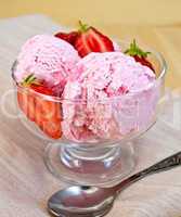 Ice cream strawberry in glass goblet on napkin and board