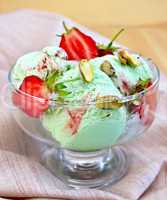 Ice cream strawberry-pistachio on napkin and board
