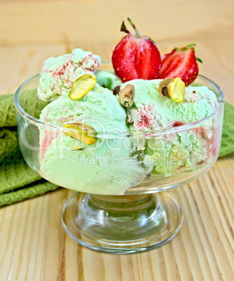 Ice cream strawberry-pistachio with napkin on board