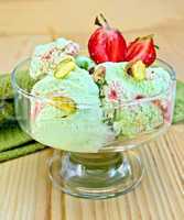 Ice cream strawberry-pistachio with napkin on board