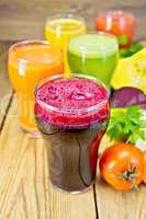 Juice beet and vegetable with vegetables on table