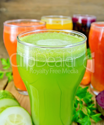 Juice cucumber and vegetable in glass with vegetables on board