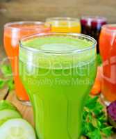 Juice cucumber and vegetable in glass with vegetables on board
