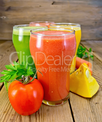 Juice tomato and vegetables in glasses on board