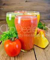 Juice tomato and vegetables in glasses on board